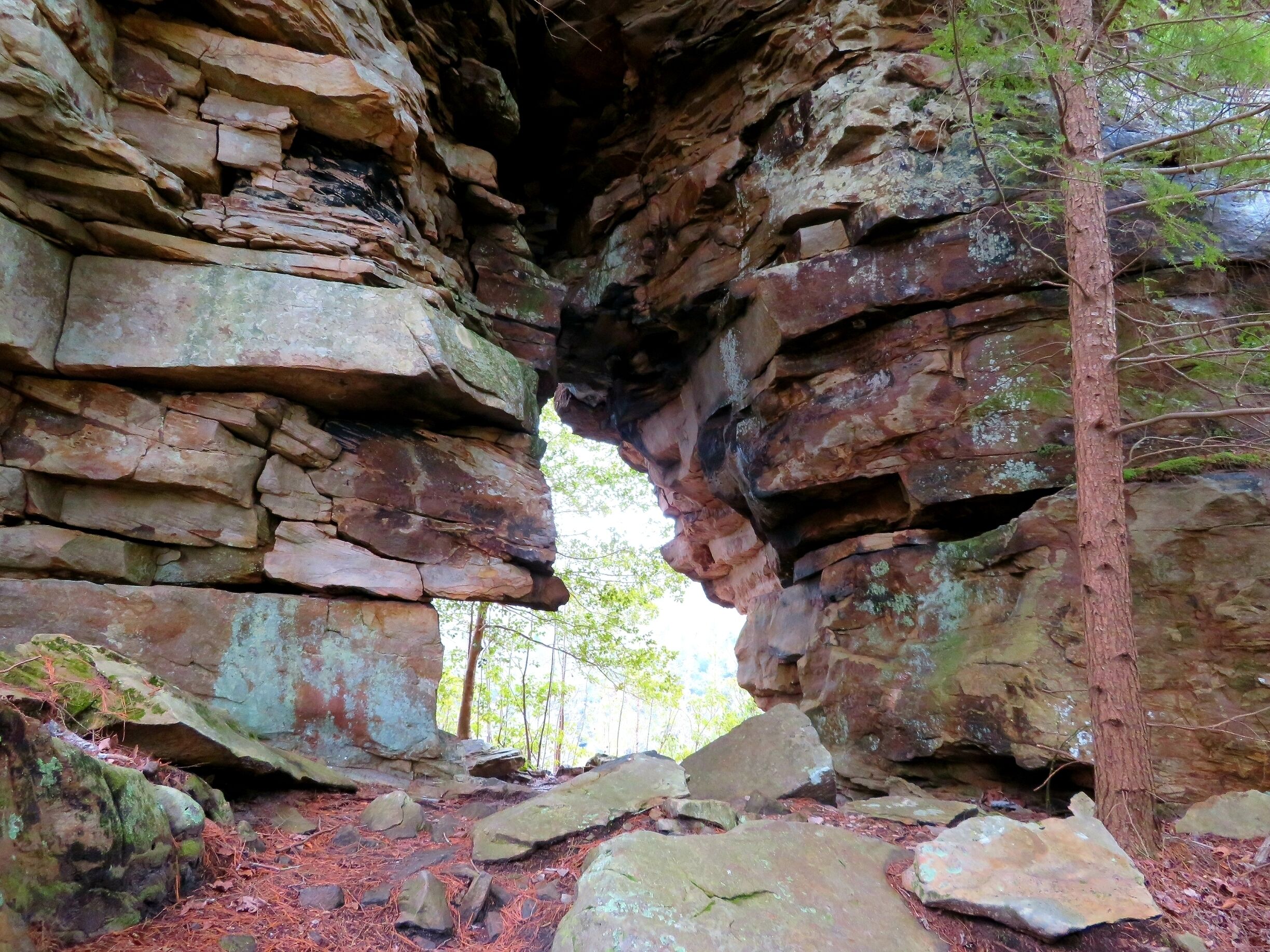 A natural rock formation with a narrow passageway.