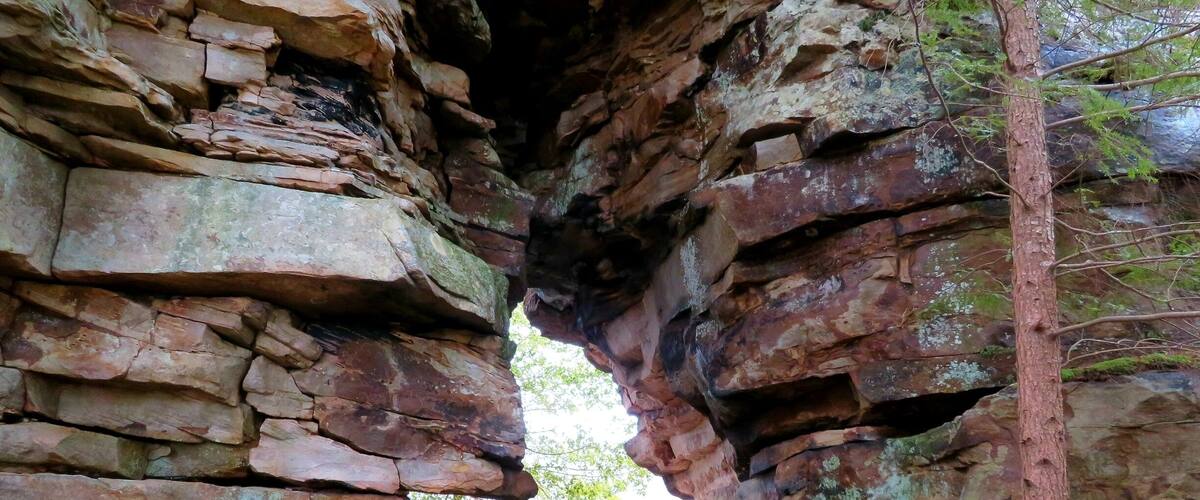 A natural rock formation with a narrow passageway.