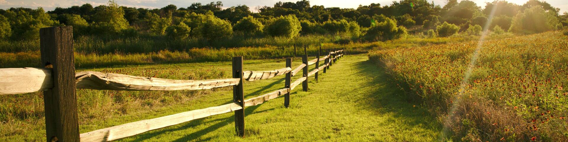 The sun sets over a ranch fence in North Texas.