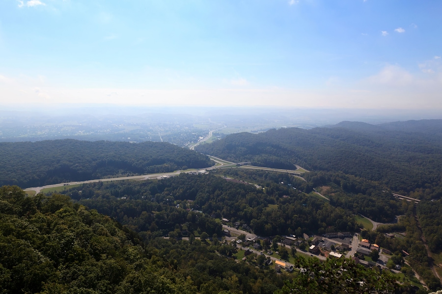 A mountainous landscape with a winding road and a small settlement.