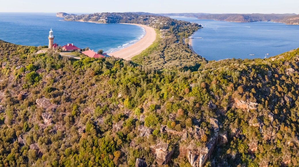Panoramic aerial drone view of Barrenjoey Head Lighthouse at Barrenjoey Headland, Palm Beach, Northern Beaches in Sydney, New South Wales, Australia on a sunny morning