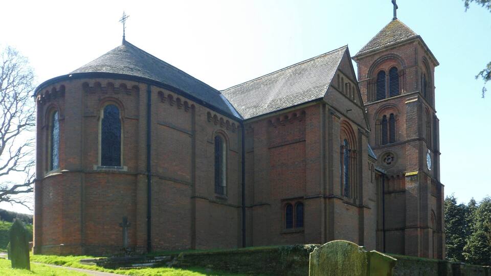 A historic church with a prominent bell tower and a dome.
