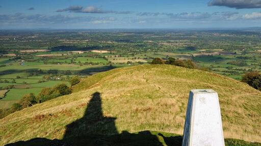 In the shadow of a hero Here we have another perception of Rodneys Pillar atop Breidden Hill, with the trig point in the foreground.