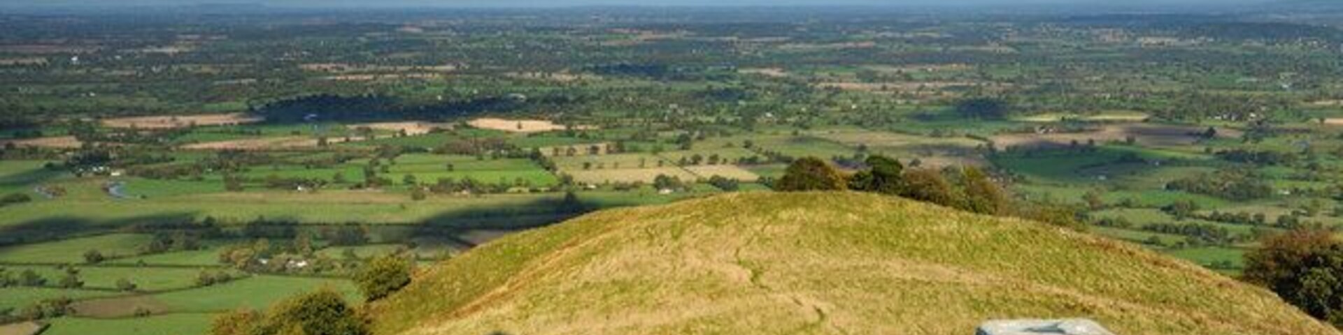 In the shadow of a hero Here we have another perception of Rodneys Pillar atop Breidden Hill, with the trig point in the foreground.