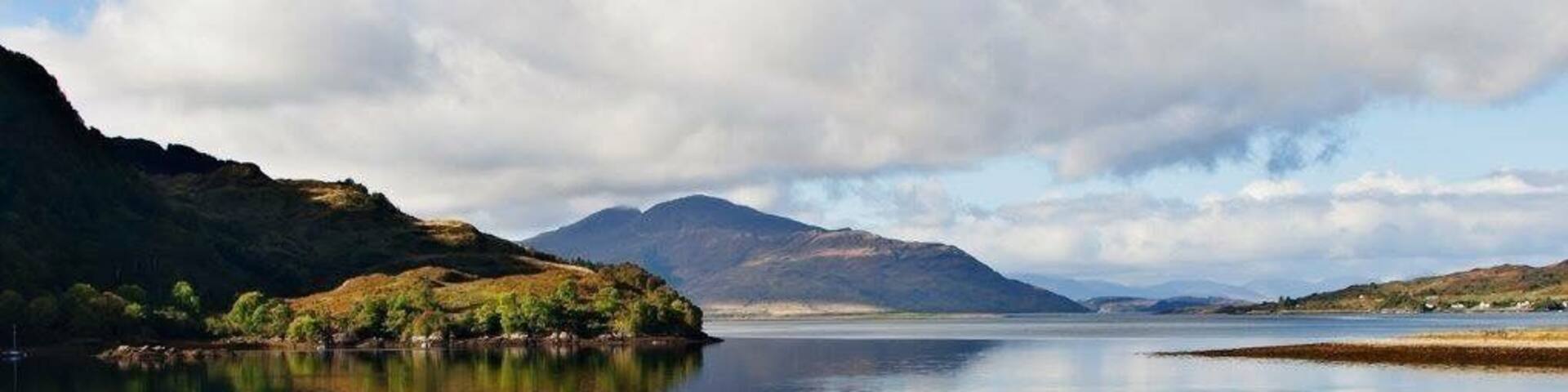 Lake at the Eilean Donan Castle. Partly cloudy reflections at the afternoon.