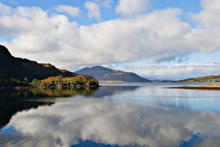 Lake at the Eilean Donan Castle. Partly cloudy reflections at the afternoon.