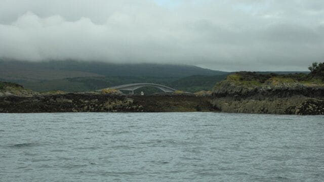 The gap on Eilean a' Mhal The Skye Bridge and Kyleakin Lighthouse, on Eilean Ban, can be seen through the gap on Eilean a' Mhal.