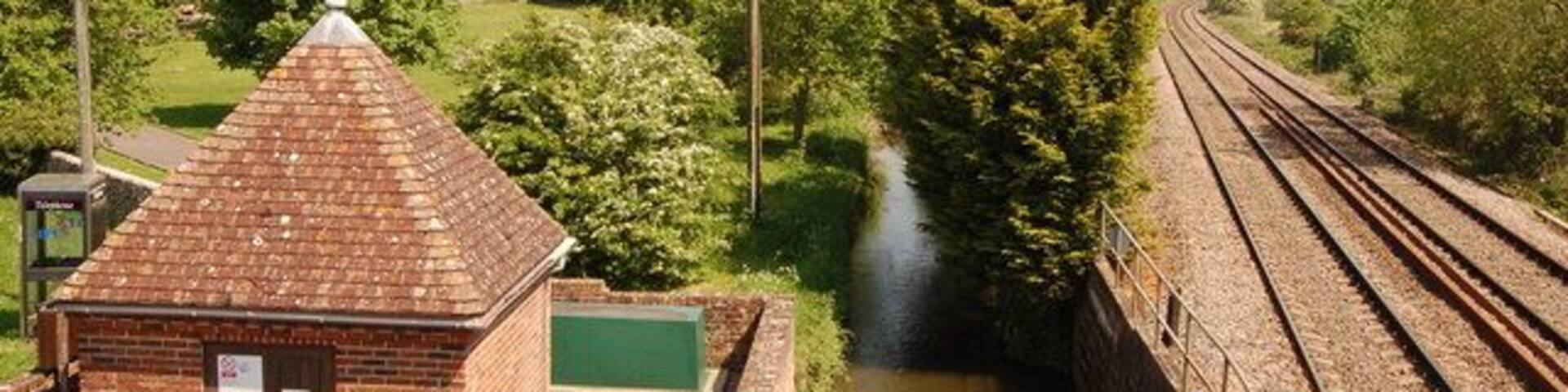 Little Bedwyn from the railway footbridge View looks northwards from the top of the railway footbridge. A Thames Water pumping station and the main railway line are in the foreground whilst Little Bedwyn church is almost obscured by the May blossom.