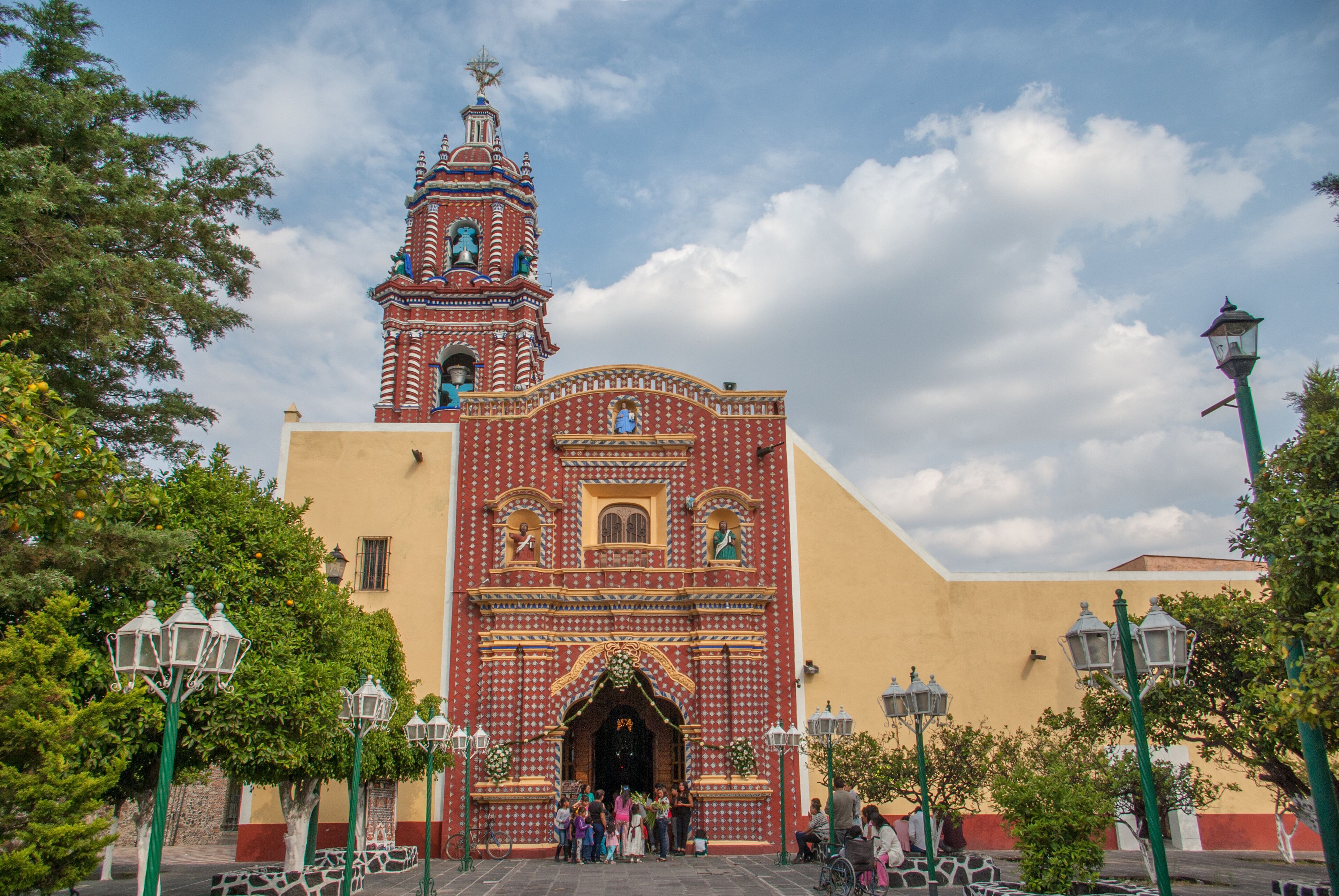 A colorful church with a bell tower and ornate decorations.