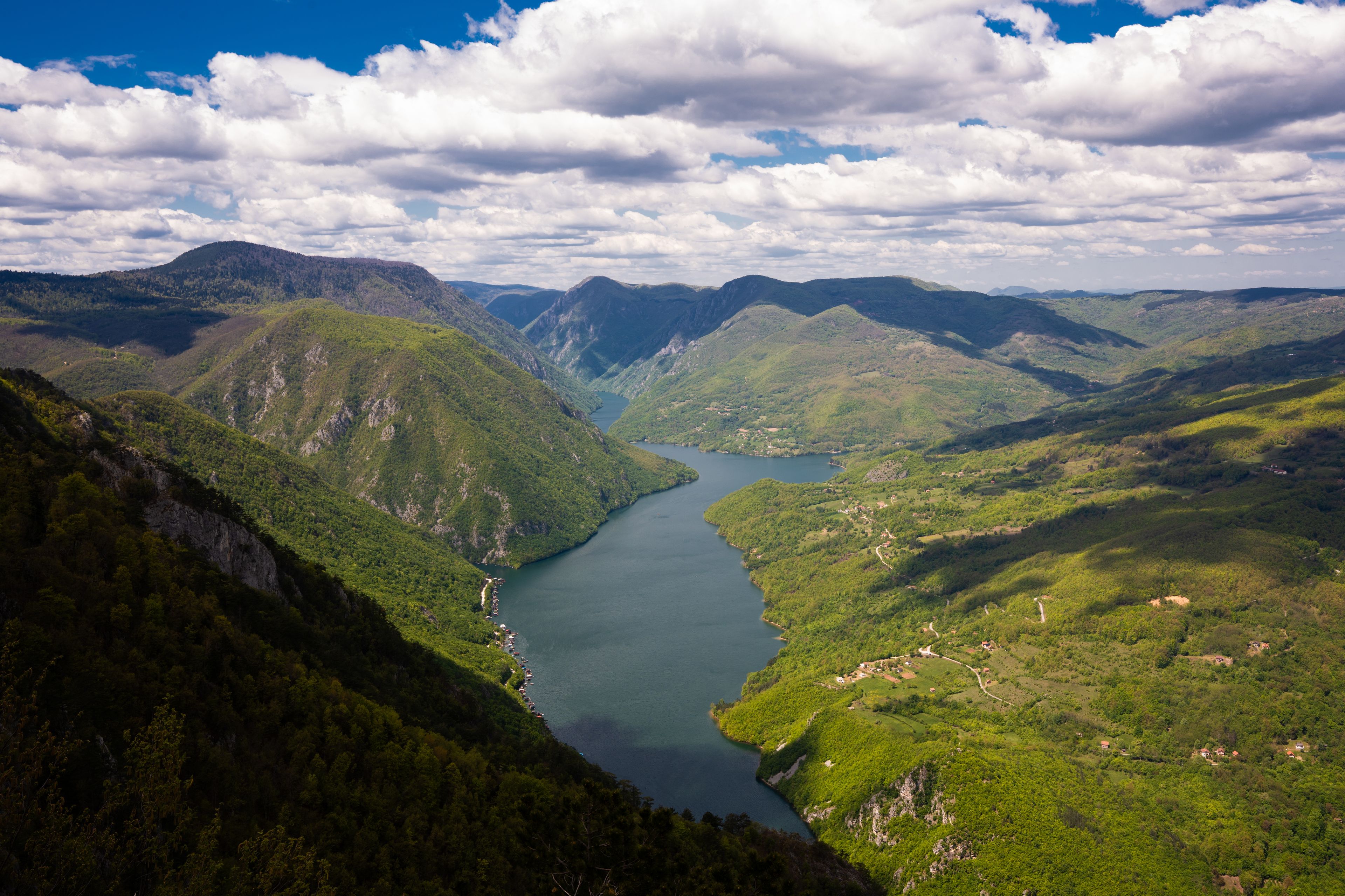 A mountainous landscape with a river winding through it.