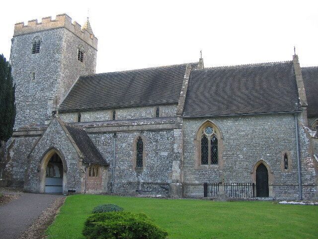 A stone church with a tower and arched windows.