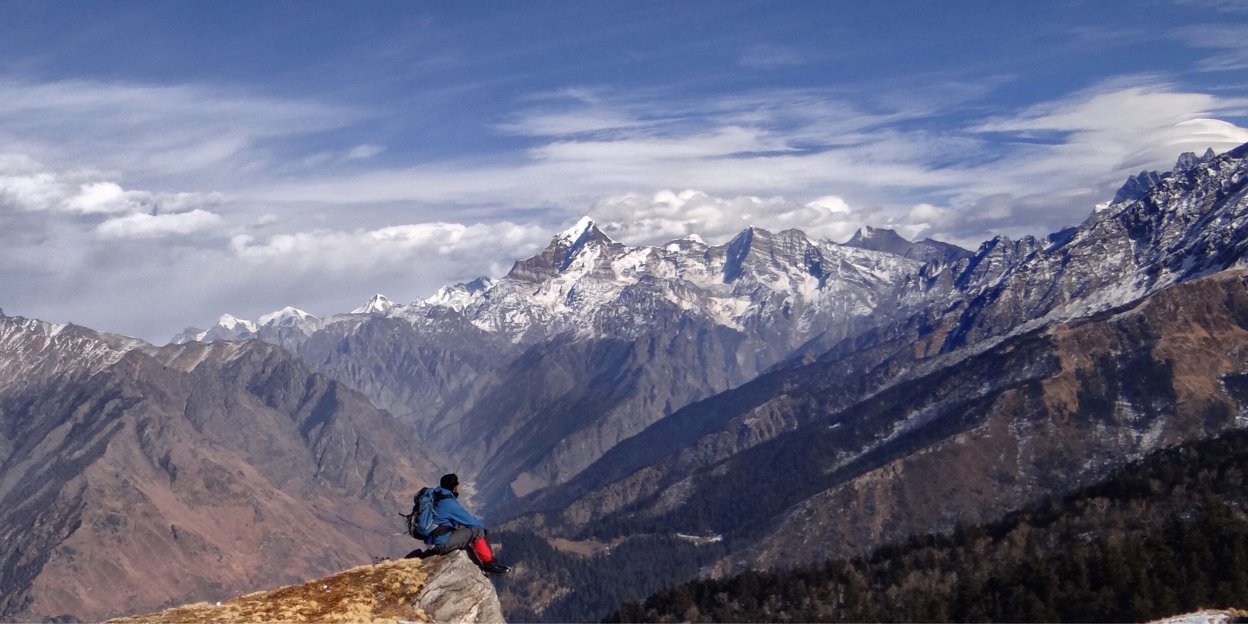 The popular Kauri pass trek is renowned to be known for its scenic meadow and mountain ranges while reaching its summit. One such spot is a hill edge just after a stone shrine where there are prayer flags hanging beside it. One can see the panoramic view of a mountain range as if it’s God’s own Dharma Production film in theatre of nature.