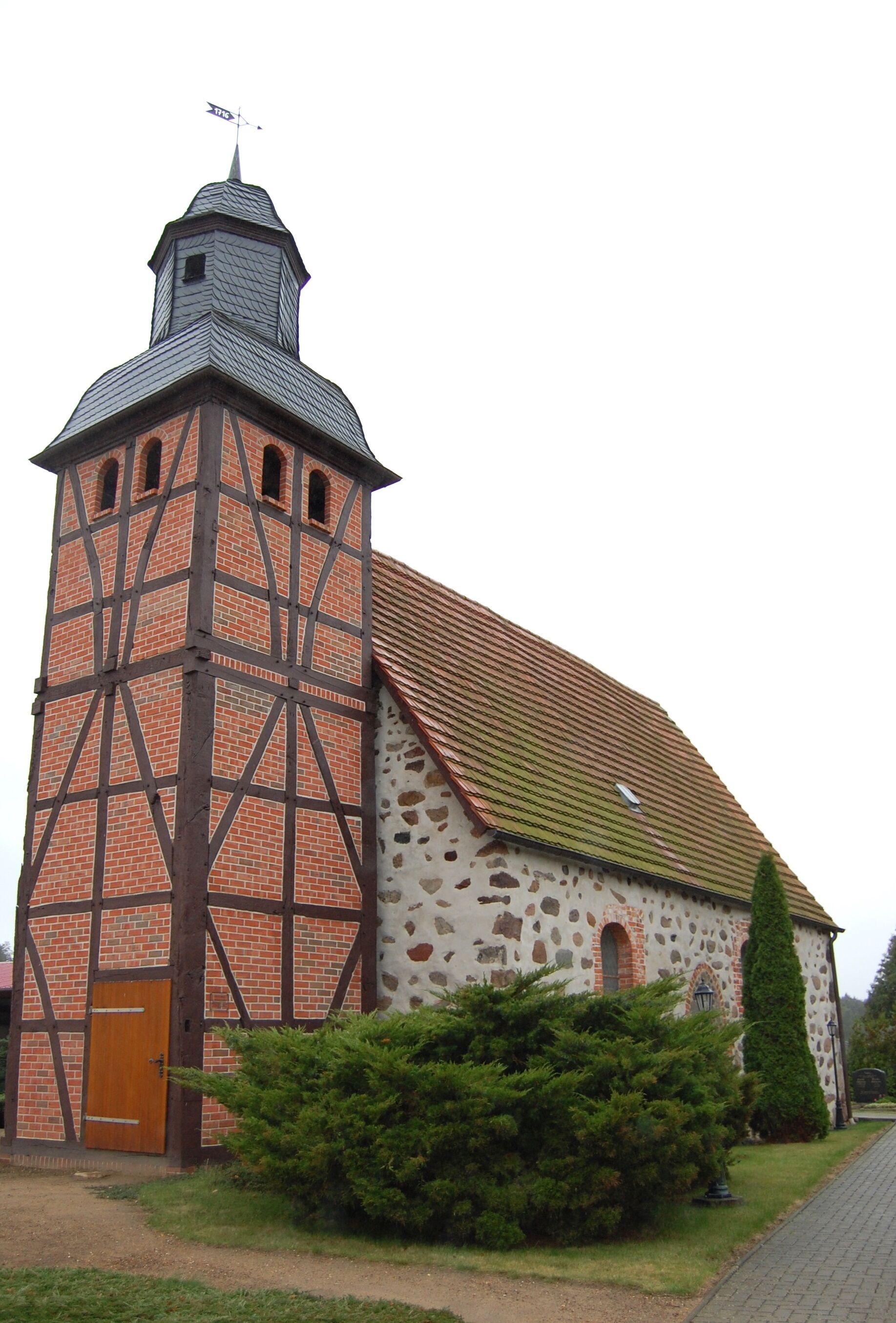 A church with a tall tower and a stone facade.