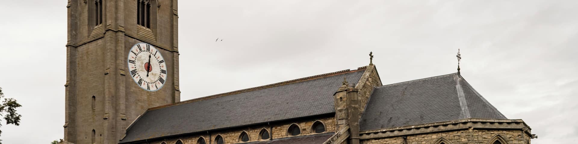 The church dates from the 13th century onwards, the chancel has been rebuilt twice, in 1741 and 1870. There is a western tower with arched openings to north and south allowing pedestrians to pass through, a nave with clerestory, north and south aisles, south porch, and chancel with apse. The tower is of three stages from the 14th century, but the belfry stage is from the 15th century. It is buttressed with embattled parapets. There are six bells. The church is famous for its one-handed clock, which dates from the 17th century. The dial is 16 feet in diameter and believed to be the largest single-handed clock in Europe. The nave arcades have five bays with octagonal piers. The north aisle is from the 14th century, with the south aisle being from the 15th century, both have human head label stops. At the east end of the south aisle is a Lady Chapel. The nave has a 14th century king post roof. The 14th century chancel arch once had a rood loft, and the access doors still remain on the south side. The south porch dates from the 15th century and has a parvis above. The chancel, with polygonal apse, was rebuilt in 1870 by T.C. Hine and Son. The church contains several memorial plaques to members of aircrew from RAF Coningsby killed in flying accidents and WWII.