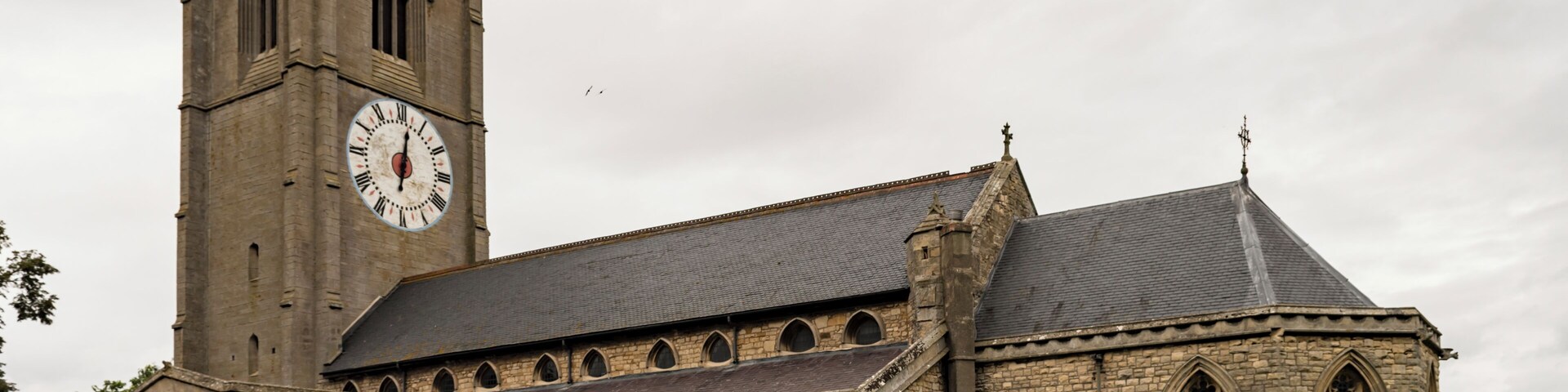 The church dates from the 13th century onwards, the chancel has been rebuilt twice, in 1741 and 1870. There is a western tower with arched openings to north and south allowing pedestrians to pass through, a nave with clerestory, north and south aisles, south porch, and chancel with apse. The tower is of three stages from the 14th century, but the belfry stage is from the 15th century. It is buttressed with embattled parapets. There are six bells. The church is famous for its one-handed clock, which dates from the 17th century. The dial is 16 feet in diameter and believed to be the largest single-handed clock in Europe. The nave arcades have five bays with octagonal piers. The north aisle is from the 14th century, with the south aisle being from the 15th century, both have human head label stops. At the east end of the south aisle is a Lady Chapel. The nave has a 14th century king post roof. The 14th century chancel arch once had a rood loft, and the access doors still remain on the south side. The south porch dates from the 15th century and has a parvis above. The chancel, with polygonal apse, was rebuilt in 1870 by T.C. Hine and Son. The church contains several memorial plaques to members of aircrew from RAF Coningsby killed in flying accidents and WWII.