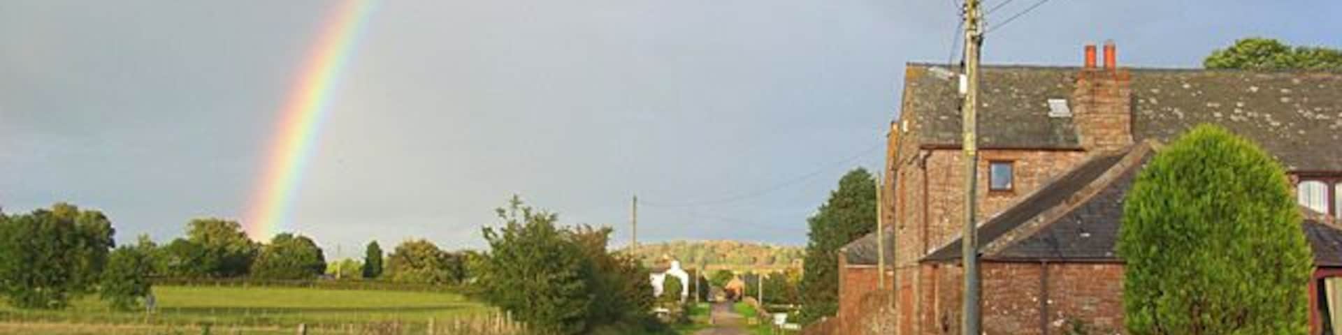 Road and house at Catterlen Just above the junction with the B5305 beyond which further houses can be seen.