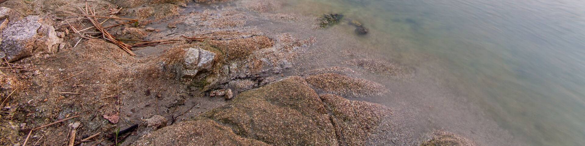 Colorful twilight water reflections in Embalse Cerro Alarcon (Cerro Alarcon Reservoir) of the Perales River. Located between Valdemorillo and Navalagamella, Madrid, Spain.