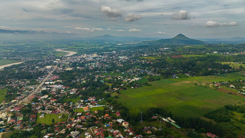 Tropical mountain with river and city with houses and river. Bukidnon, Philippines. Mindanao.
