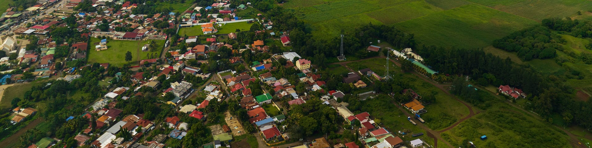 Tropical mountain with river and city with houses and river. Bukidnon, Philippines. Mindanao.