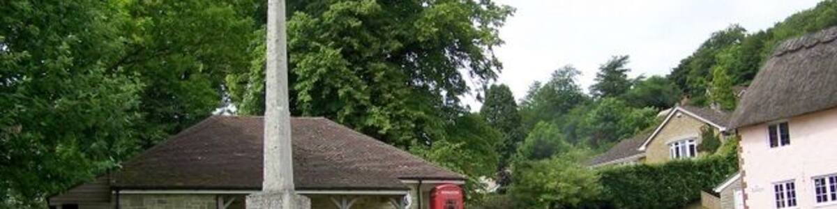 Village green, East Knoyle A K6 type telephone box set against Wren's Store with the village war memorial.