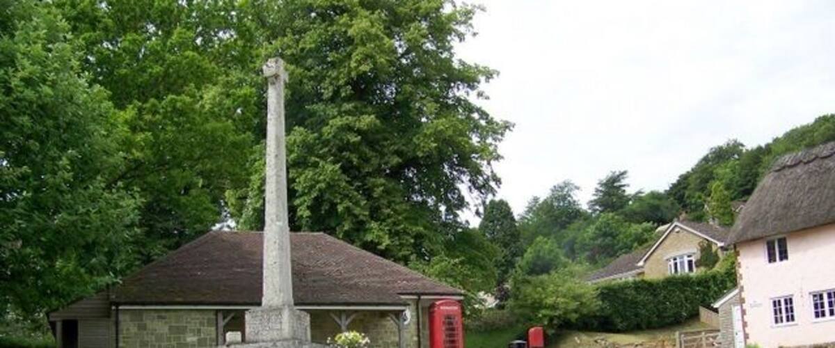 Village green, East Knoyle A K6 type telephone box set against Wren's Store with the village war memorial.