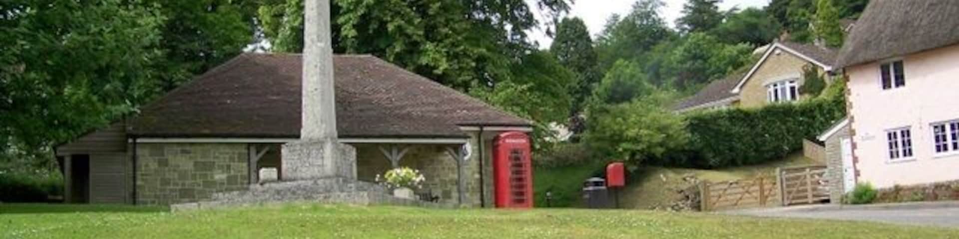 Village green, East Knoyle A K6 type telephone box set against Wren's Store with the village war memorial.