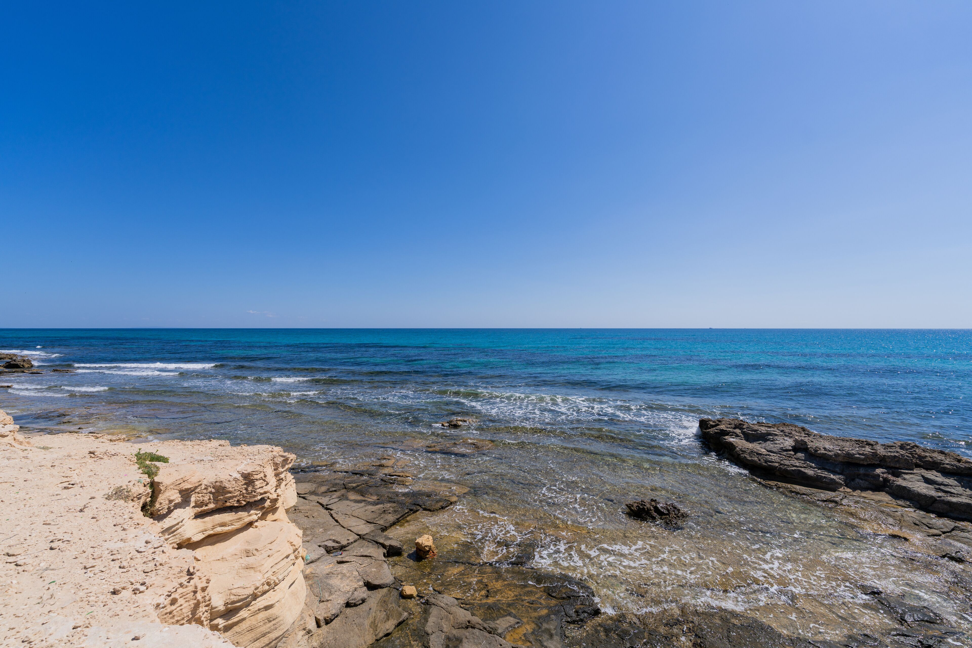 Rocky Shoreline and Turquoise Waters on Hergla Coast, Tunisia