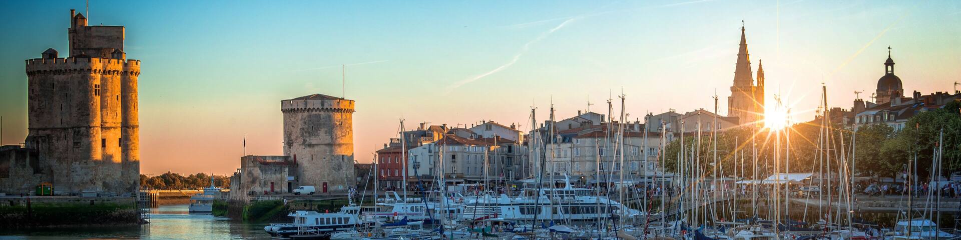 Panorama of the old harbor of La Rochelle, France at sunset