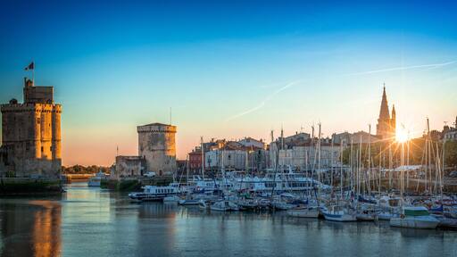 Panorama of the old harbor of La Rochelle, France at sunset