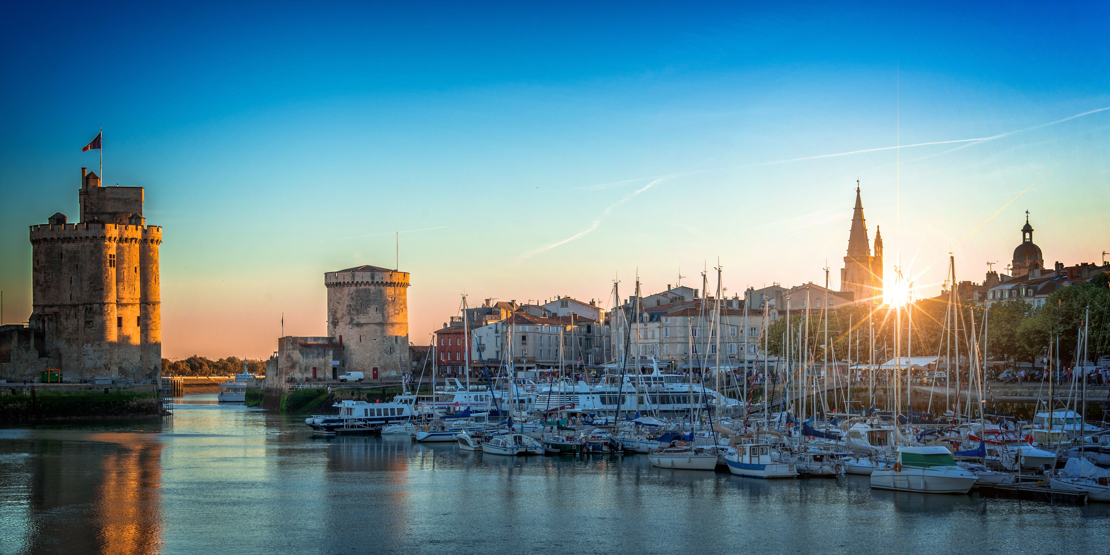 A harbor with boats, a castle, and a church.