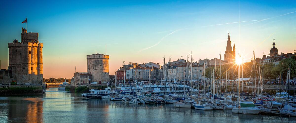 A harbor with boats, a castle, and a church.