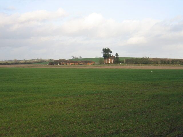 Farmland near Luddington. Looking NE across the north eastern corner of the square from the Luddington Road with Sandfields Farm in an adjacent square in the distance.
