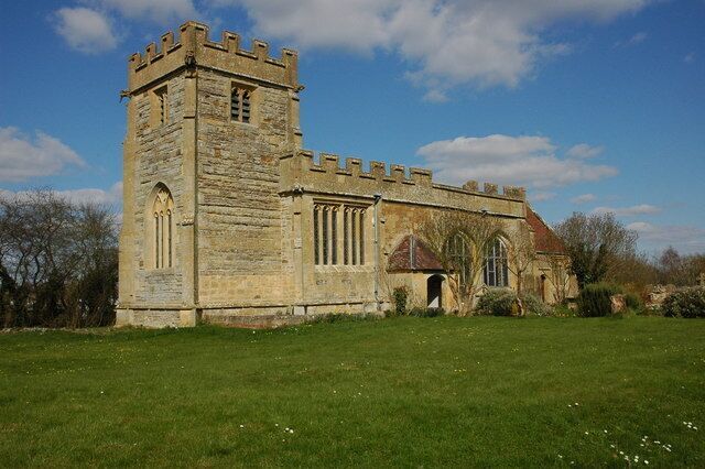 A historic stone church with a tower and arched windows.