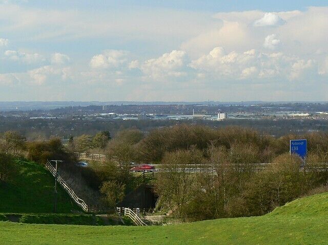 Looking towards Swindon from the south-east near Liddington The blue sign at the right indicates the approach to Junction 15 of the M4. Turn left (south) for Marlborough and mid and south Wiltshire. Turn right for Swindon, Cricklade, Cirencester, Cheltenham and Gloucester.