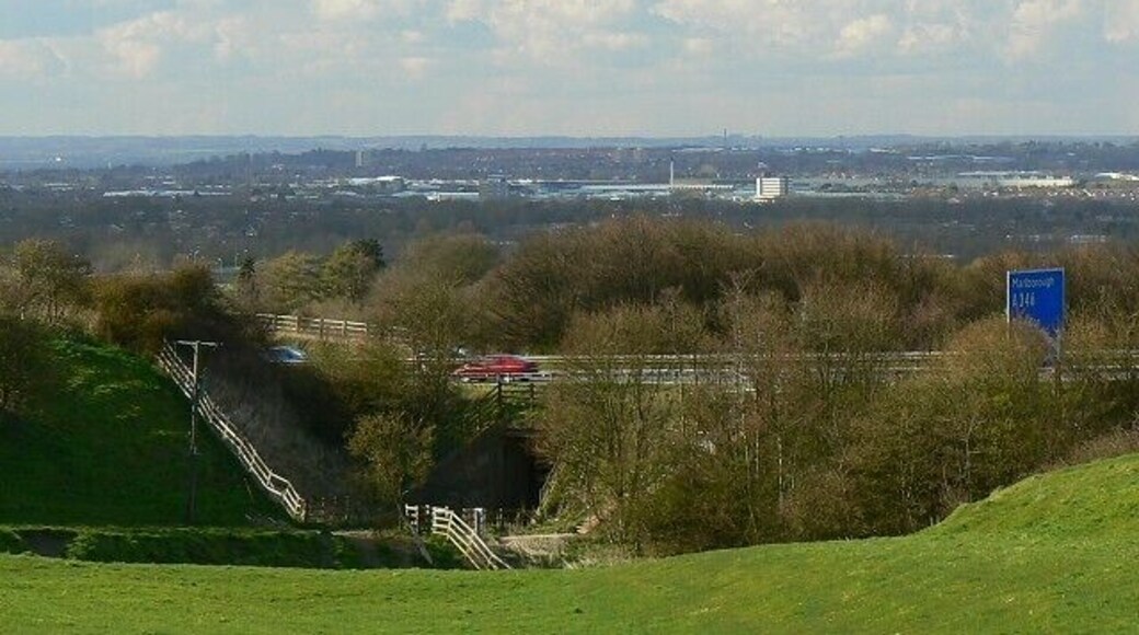 Looking towards Swindon from the south-east near Liddington The blue sign at the right indicates the approach to Junction 15 of the M4. Turn left (south) for Marlborough and mid and south Wiltshire. Turn right for Swindon, Cricklade, Cirencester, Cheltenham and Gloucester.