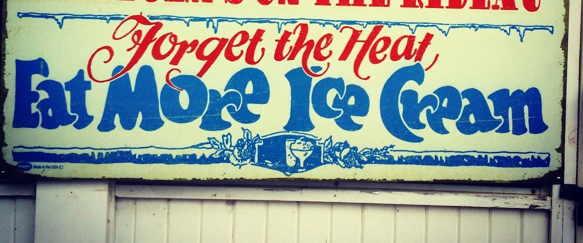 A vintage sign advertising ice cream with the text "Kilborn's on the Rideau" and "Forget the Heat Eat More Ice Cream."