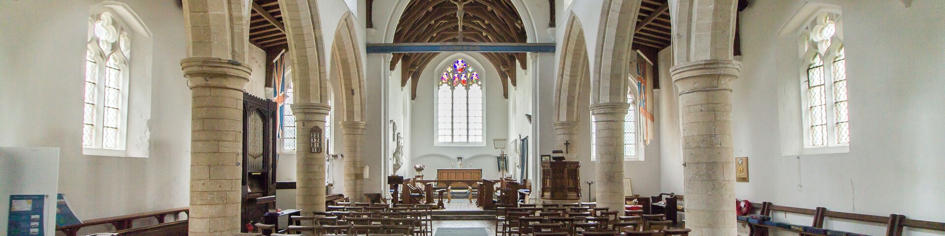 The church consists of a west tower, four-bay nave and aisles, chancel, and a north porch. The three stage tower was originally built in the early 15th century, but partly fell in the early 19th century and was probably reduced in height at that time. There is a battlemented parapet with crocketted pinnacles and gargoyles. It is decorated with Shields and panels of black flints. The nave has 13th century north and south arcades of four bays, with round piers and seat bases. There is a small perpendicular clerestory. There is a rood beam with a rood. The chancel has a finely decorated exterior east wall with checker patterns and three (empty) niches. There are also several mass dials. The chancel has a 15th century canopy over its piscina and sedilia. The north east end of the nave originally had a Chapel, There is a squint, a tomb slab from circa 1300 and a wall recess. In the centre of the chancel floor is a large brass to Sir William Calthorpe, died 1420. Burnham Thorpe is famous for being the birthplace of Lord Nelson, and he was baptised in the church. There are several references to him in the church. The lectern is made from a beam from HMS victory, given by Lords of the Admiralty in 1881. There is also a bust of Nelson and a Memorial for his father who was rector at the church and died in 1802. The church was renovated for the centenary of the Battle of Trafalgar in 1905. There is a Purbeck marble font dating from the 13th century with pointed arches on the faces. There is a small but fine organ which is currently the earliest survival by maker Samuel Street. Pic by Jenny.