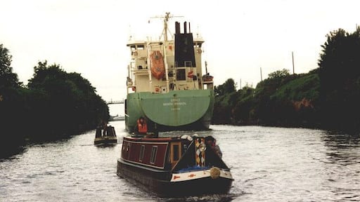 Little & large on the Manchester Ship Canal Stragglers from the flotilla organised by the Inland Waterways Association to mark the Centenary of the Ship Canal were suddenly presented with having to squeeze past an ocean-going freighter as they approached Latchford Locks.