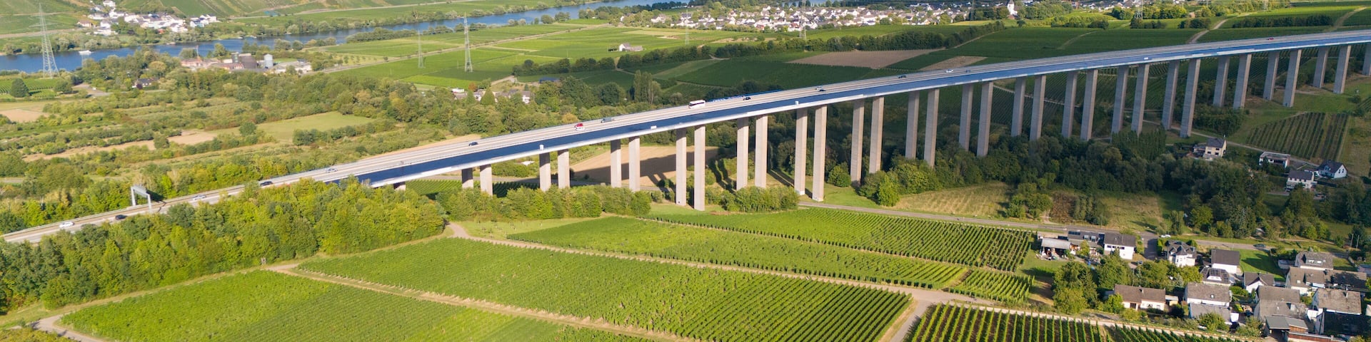 Moselle Viaduct Longuich, vineyard in Mosel valley, bridge of highway crossing river near Trier, german autobahn, aerial view