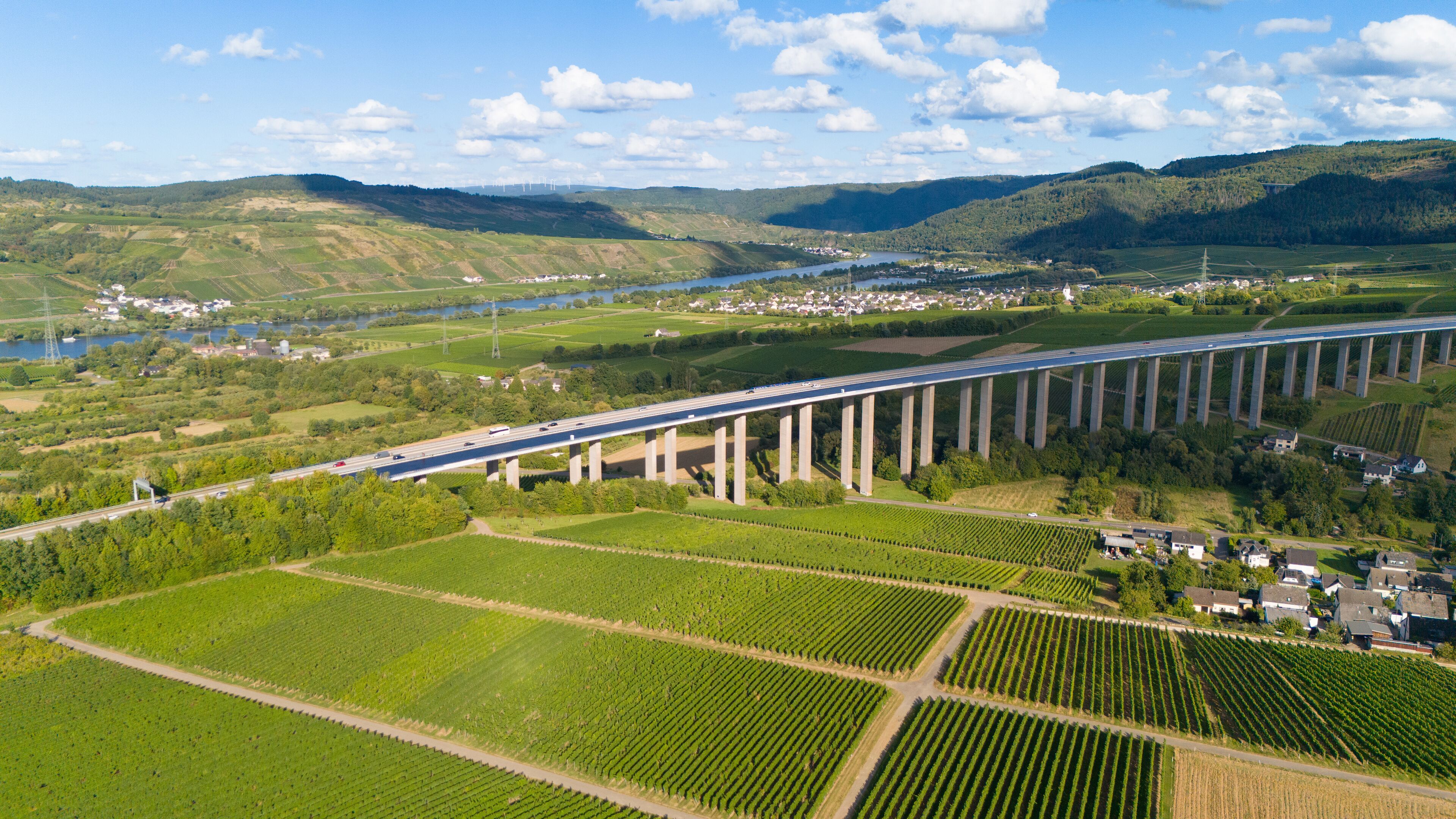Moselle Viaduct Longuich, vineyard in Mosel valley, bridge of highway crossing river near Trier, german autobahn, aerial view