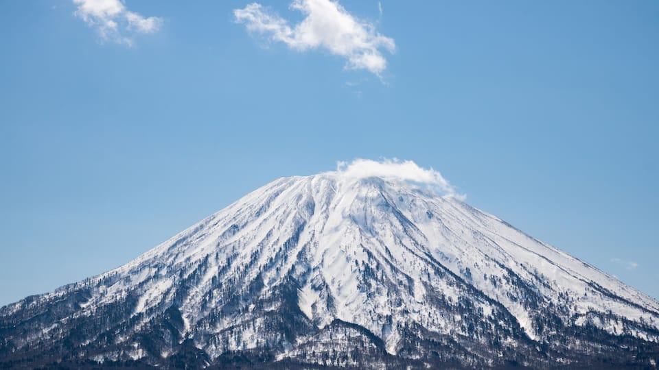 A snow-covered mountain with a clear sky.