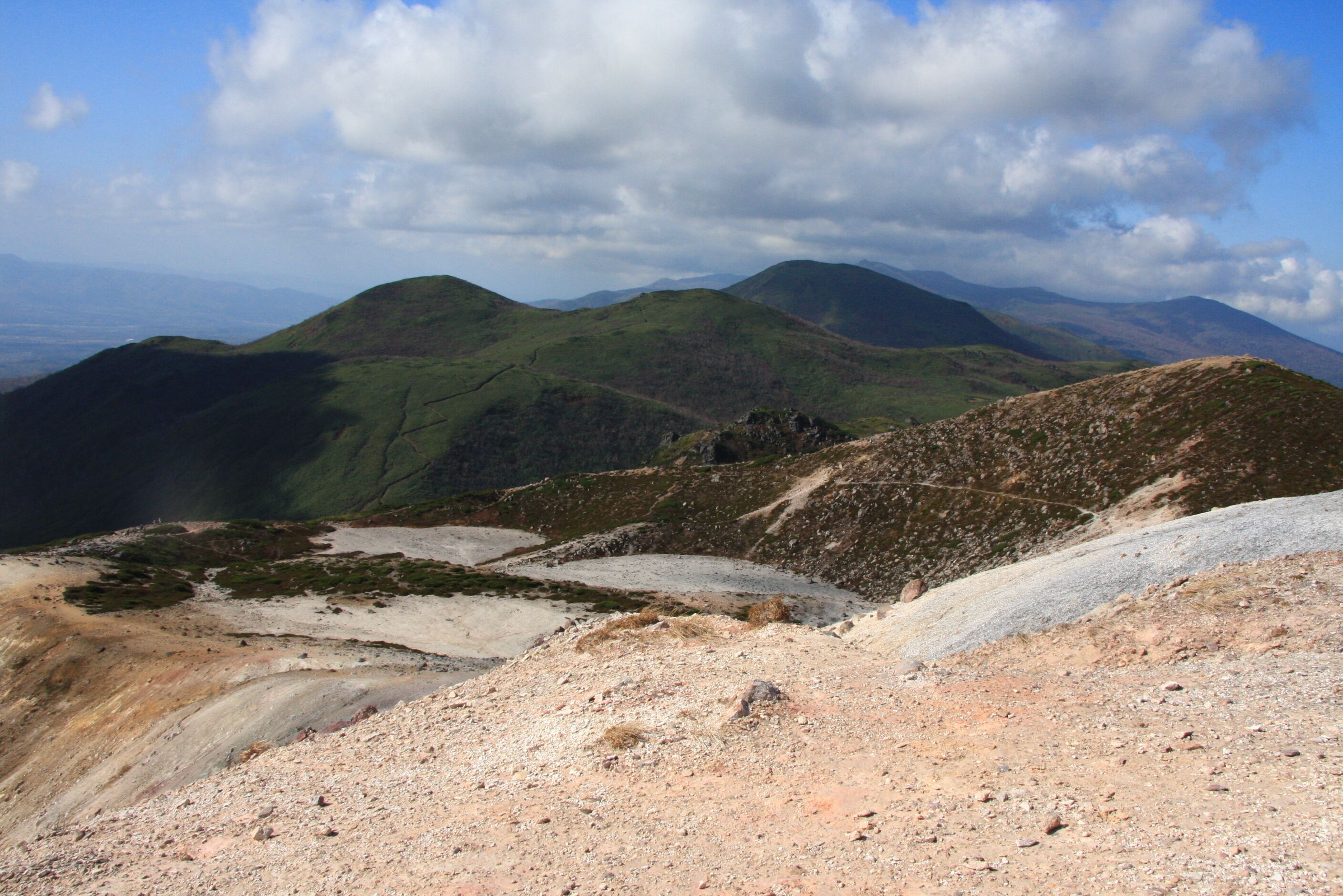 A mountainous landscape with rolling hills and a clear sky.