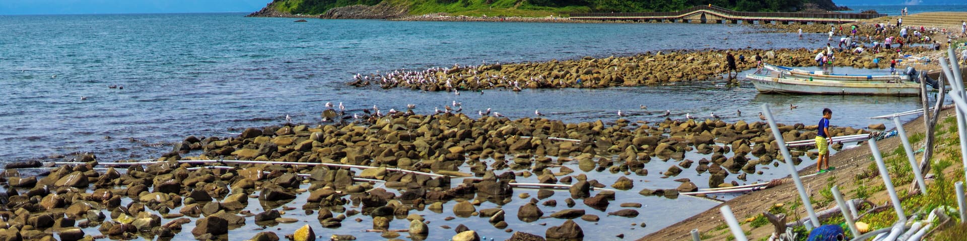 Awsome island in northern Japan. Plenty of spots along the road to stop at the water. There is a small market area just before the bridge to the island and hermit crabs for kids to chase after.