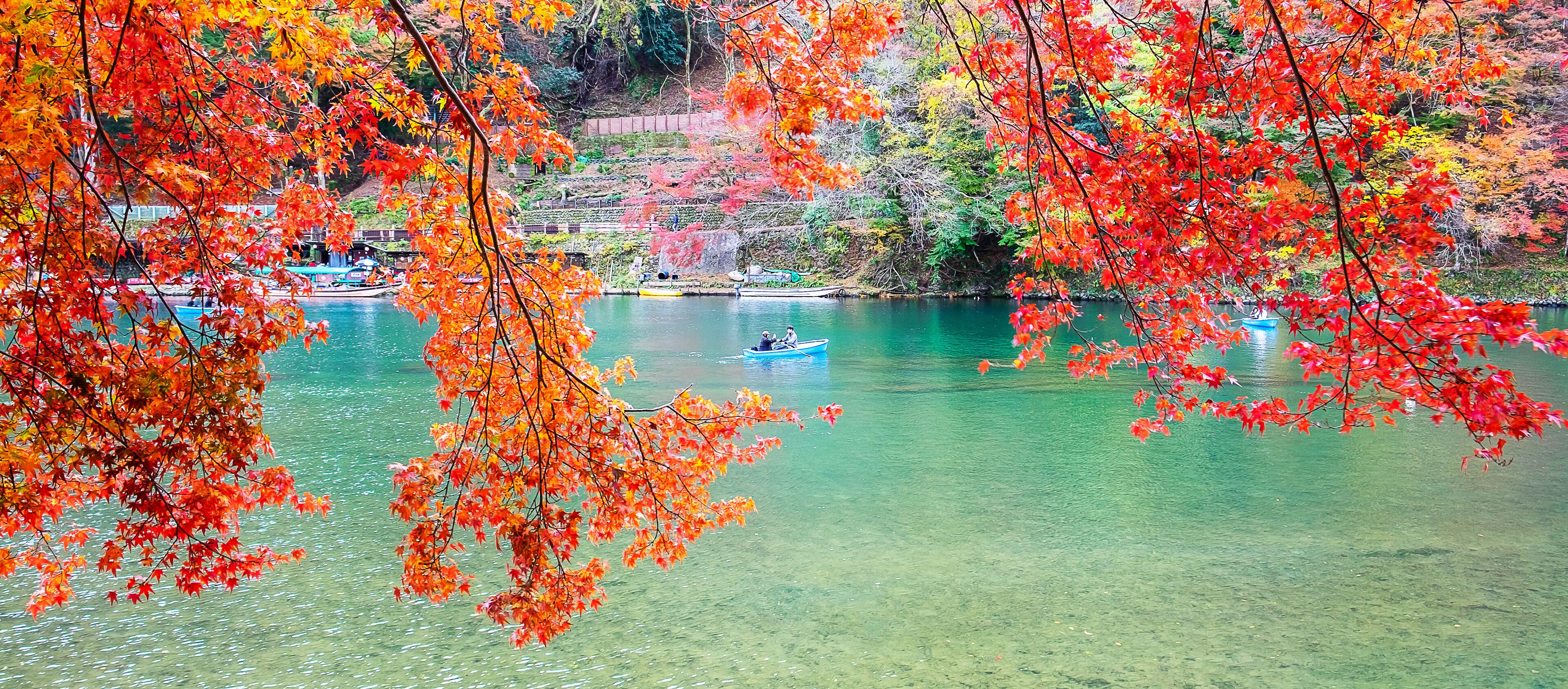 A serene lake surrounded by vibrant autumn foliage.