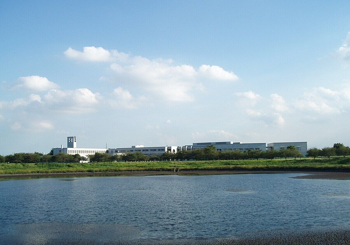 A river with a building complex in the background.