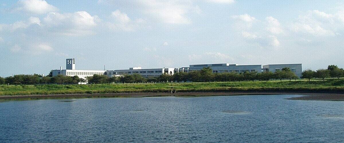 A river with a building complex in the background.