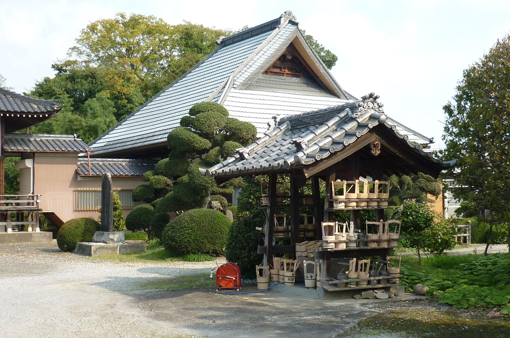 A traditional Japanese building with a tiled roof and wooden structures.