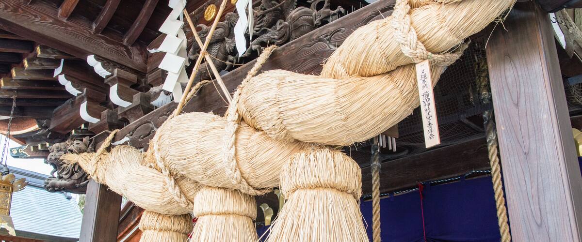 Traditional Japanese paper lanterns hanging from a wooden structure.