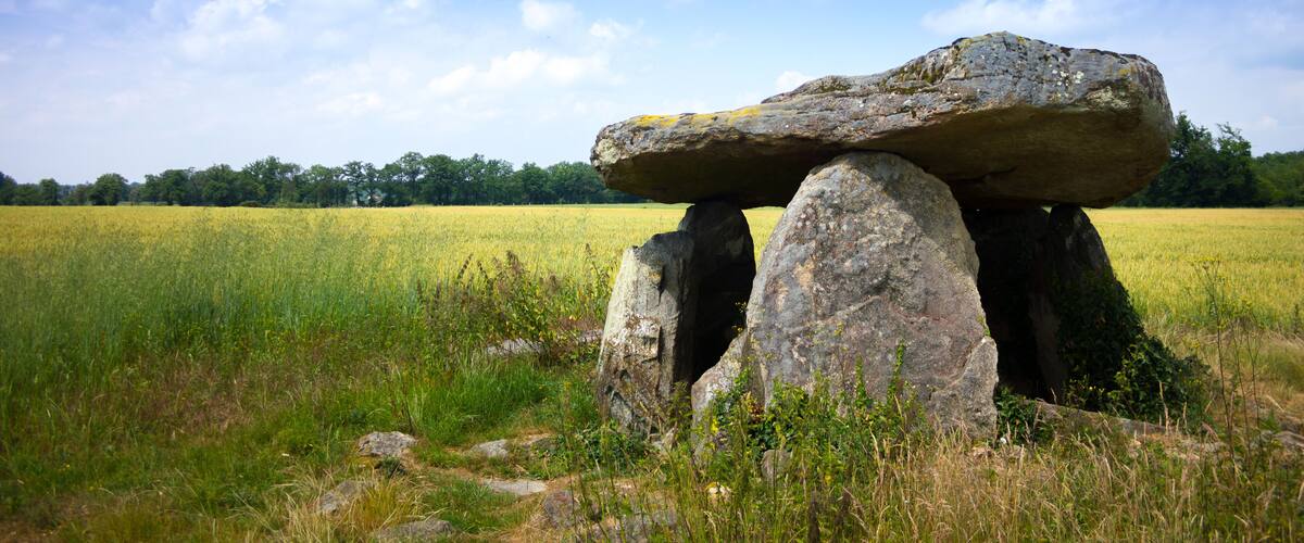 A stone circle in a field with a clear sky.