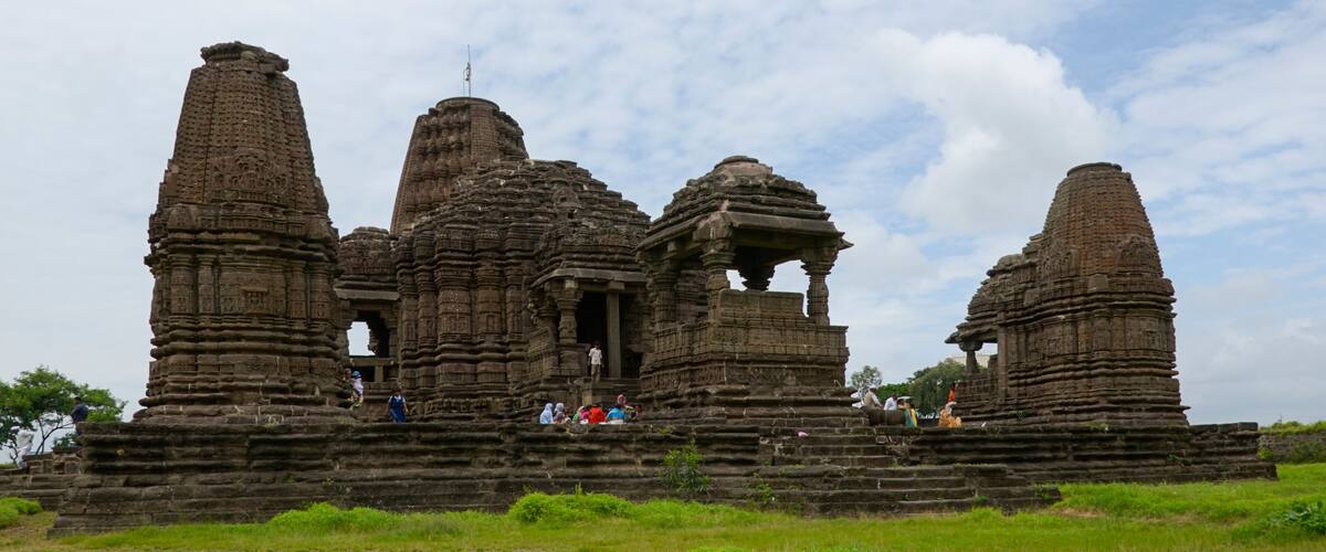 A large ancient temple complex with multiple towers and intricate carvings.